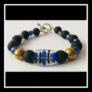 Blue, black, and gold bracelet